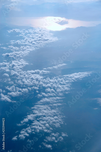 Heavenly landscape with shining sun. White clouds on blue sky