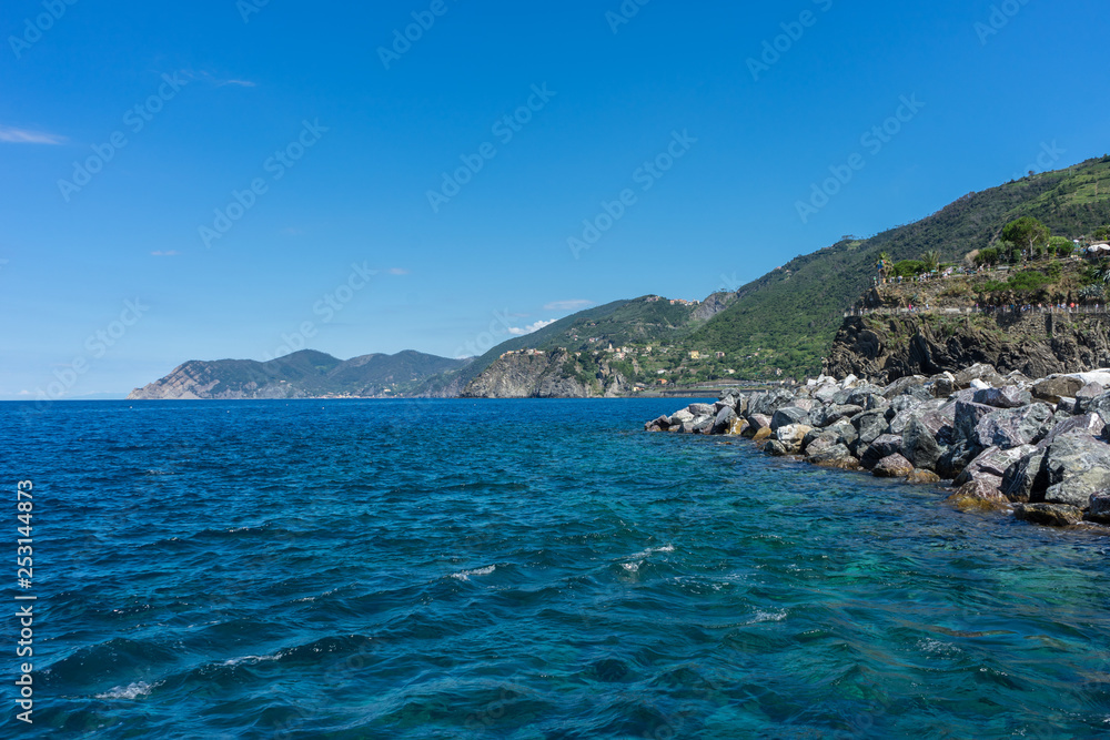 Italy,Cinque Terre,Riomaggiore, a large body of water with a mountain in the ocean