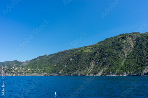 Italy,Cinque Terre,Riomaggiore, a large body of water with a mountain in the background