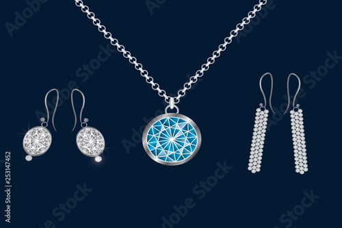 A set of jewelry. The chain and earrings, round in blue. Set decoration on a gray background.