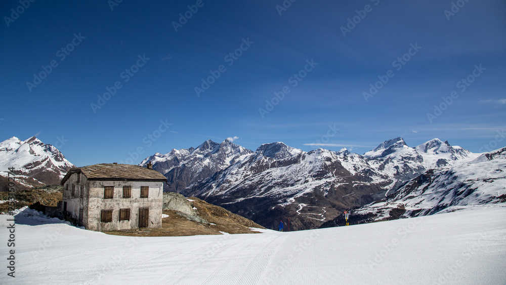 Stone Hut in the snowy Swiss Moutains