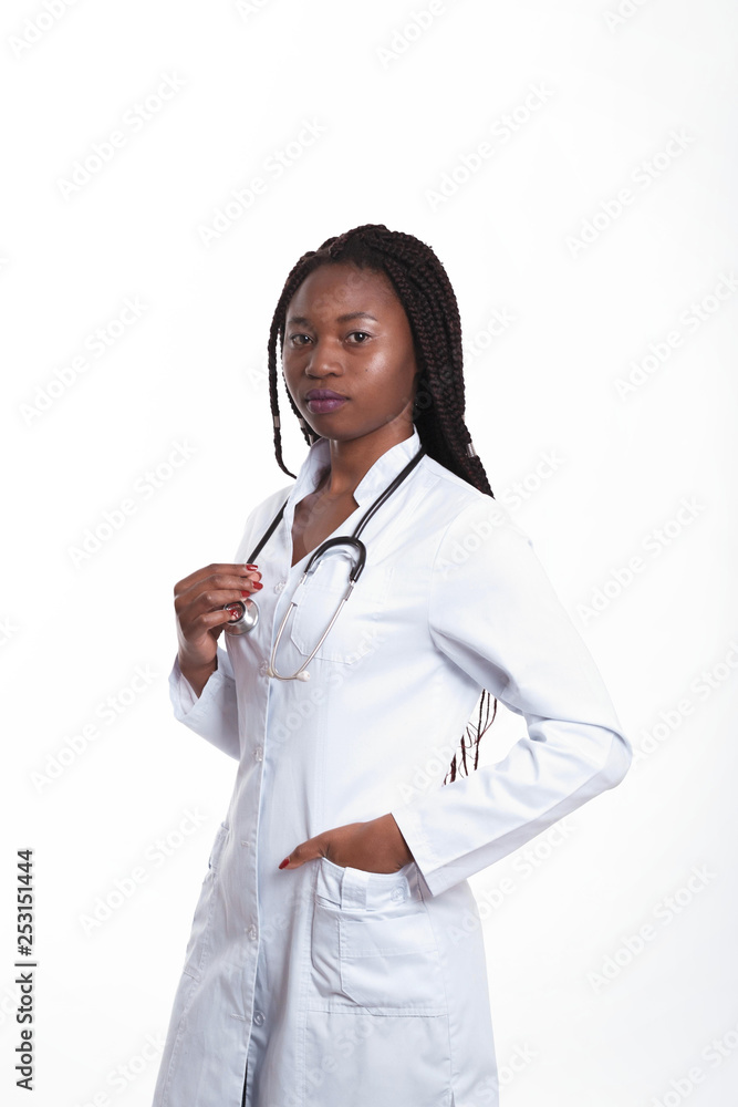 Serious Female american african doctor, nurse woman wearing medical coat with stethoscope. Happy excited for success medical worker posing on light background isolated Serious Female american african doctor, nurse woman wearing medical coat with stethoscope. Happy excited for success medical worker posing on light background isolated