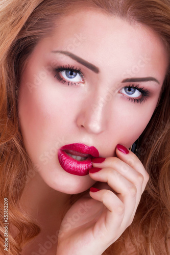 Close-up portrait of young beautiful woman with red sensual lips