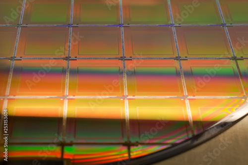 Silicon Wafer and Microcircuits - A wafer is a thin slice of semiconductor material, such as a crystalline silicon, used in electronics for the fabrication of integrated circuits. photo