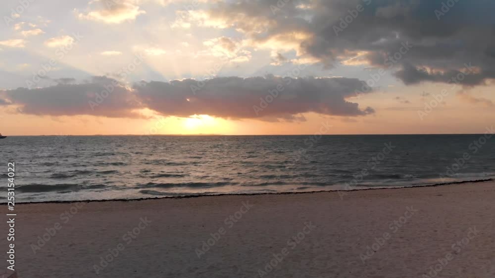 A tropical beach and ocean at sunrise near Cancun, Mexico. A tropical beach and ocean at sunrise near Cancun, Mexico.