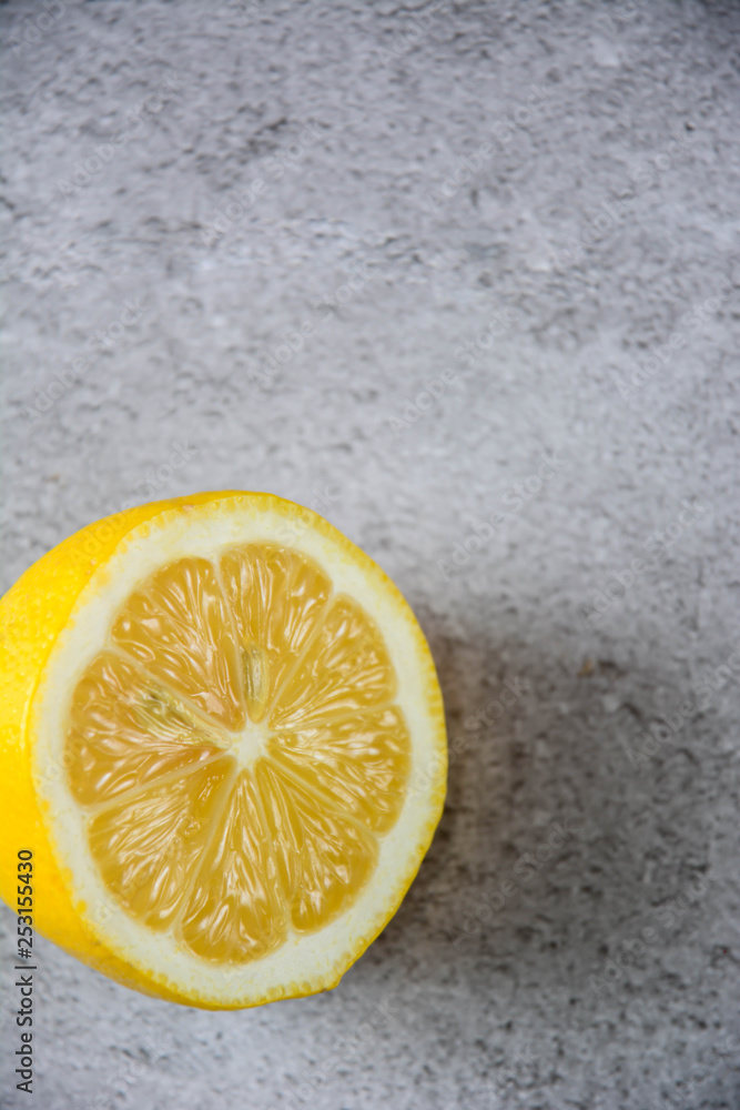 Lemon slice, isolated on a grey background top view. Vertical. Copy space. Lemon slice, isolated on a grey background top view. Vertical. Copy space.