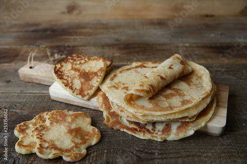 pancakes on a board on a rustic wooden table with space for text