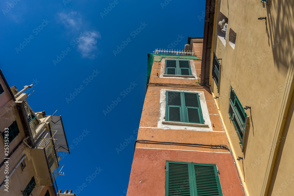 Italy,Cinque Terre,Riomaggiore, a large tall tower with a clock on the side of a building