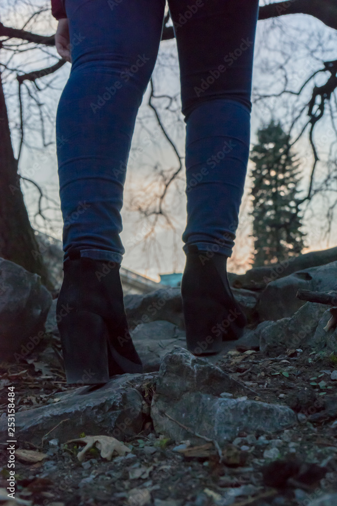 Woman with black Boots and blue jeans going up stairs rocks Woman with black Boots and blue jeans going up stairs rocks