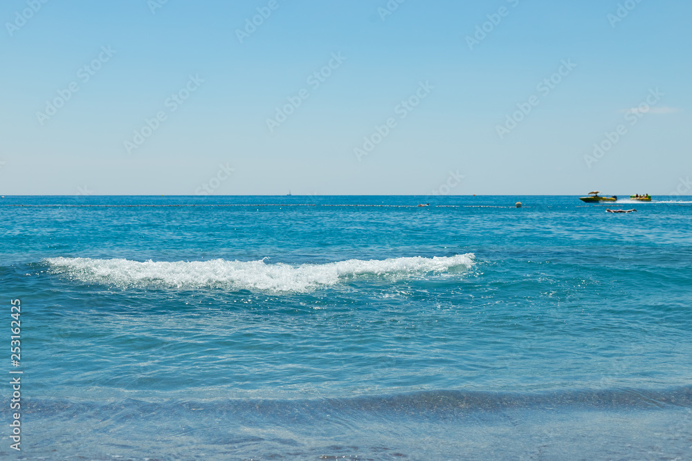 Soft wave of the turquoise sea . Natural summer background with copy space.azure waves.summer seascape.Fantastic view of the azure sea. Clear sky on a sunny day without clouds.sunlight reflection