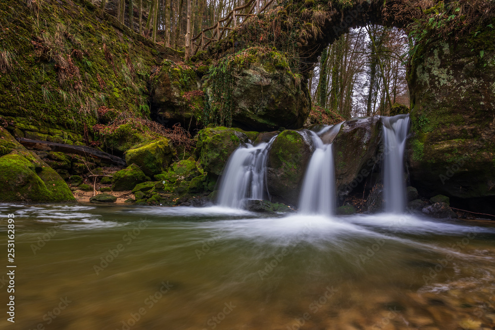 Fototapeta premium The Schiessentümpel is a small and picturesque waterfall on the Black Ernz river. Mullerthal - Luxembourg’s Little Switzerland.