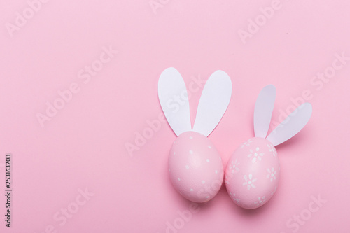 Pink easter eggs in nest on pastel color background with space. Concept