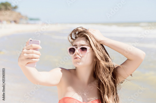 Portrait of a pretty teenage girl with long hair and sunglasses