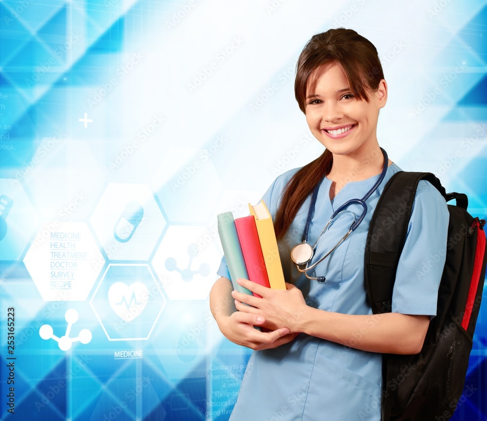 Attractive young female medical student with backpack and books on white background Attractive young female medical student with backpack and books on white background