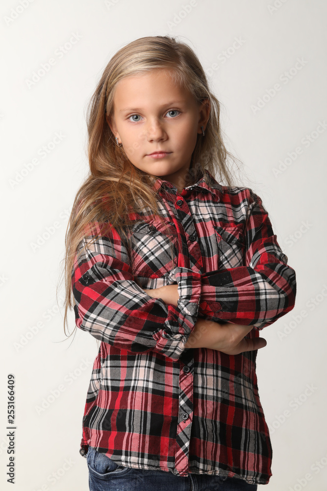 Portrait of a girl with long blond hair wearing a plaid shirt. White background Portrait of a girl with long blond hair wearing a plaid shirt. White background