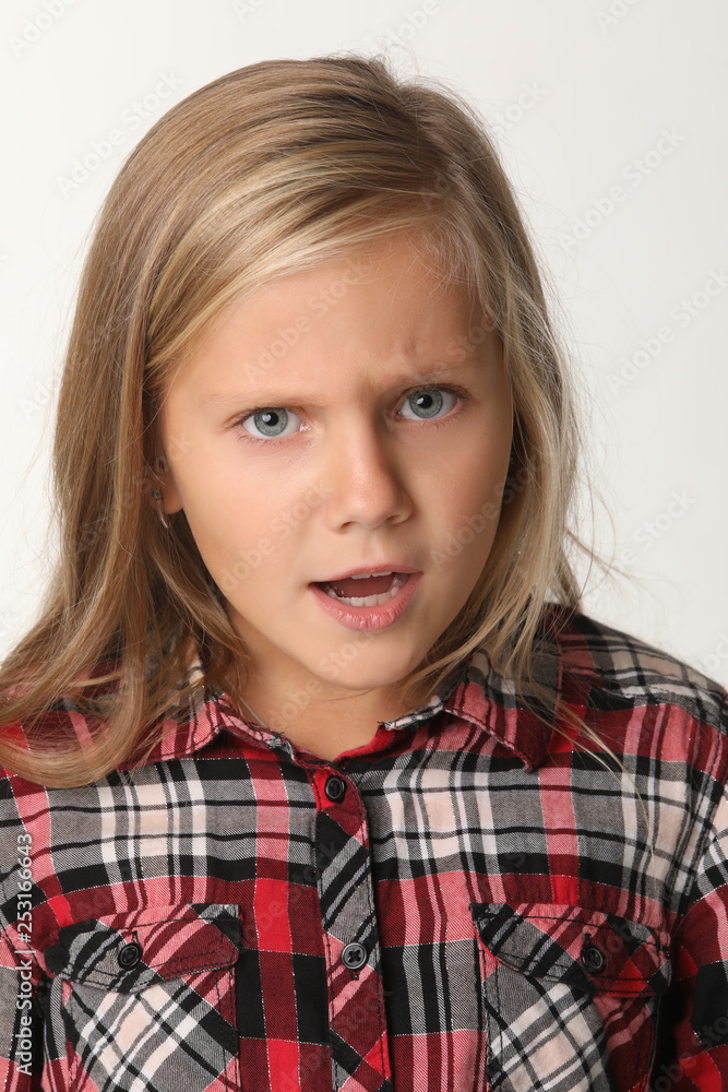 Close up of a portrait of a girl with blue eyes and blond hair. White background Close up of a portrait of a girl with blue eyes and blond hair. White background