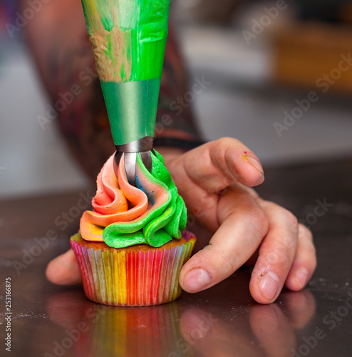 Colorful cupcakes with rainbow cream.