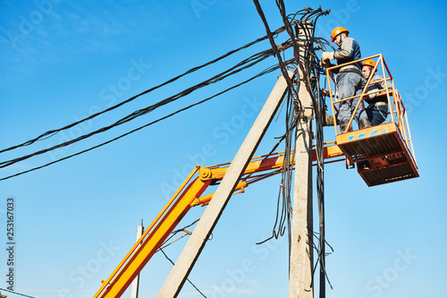 power electrician lineman at work on pole