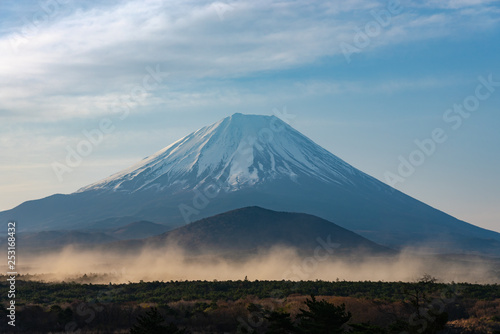 Close up Mount Fuji with natural fine sand flying up in the air. Landscape of The World Heritage. view at Lake Shoji ( Shojiko ) in the morning. Fuji Five Lake region, Minamitsuru, Yamanashi, Japan.