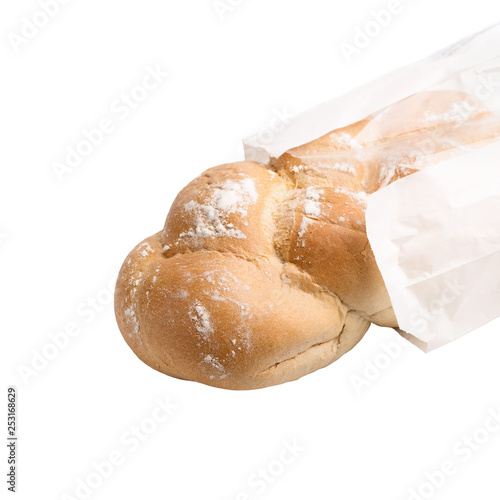 bread with sesame in a paper bag isolated on white background  close up