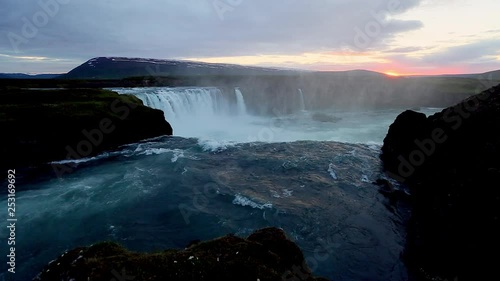 The rapid flow of water powerful Godafoss cascade. Location place Bardardalur valley of Iceland. photo