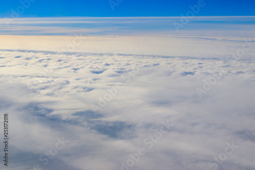 Beautiful white clouds in blue sky. View from airplane © olyasolodenko