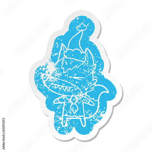 angry wolf boss cartoon distressed sticker of a wearing santa hat