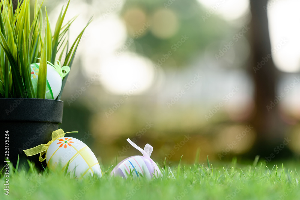 Fototapeta premium Decorated Eggs lay on grass prepared for Easter celebration
