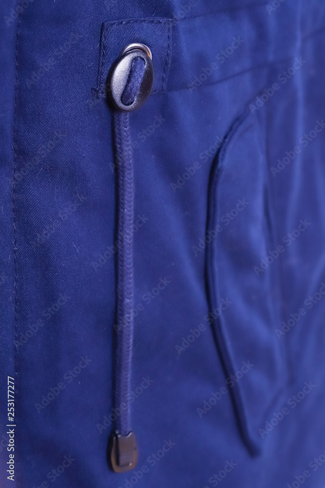 Close up of blue jacket pocket , winter fashion outfit. Jacket isolated on white background. Close up of blue jacket pocket , winter fashion outfit. Jacket isolated on white background.