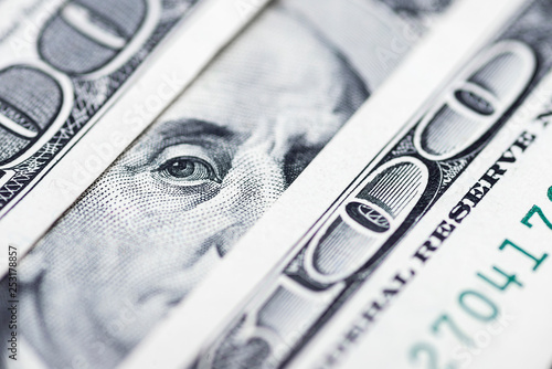 Benjamin Franklin's eyes from a hundred-dollar bill. The face of Benjamin Franklin on the hundred dollar banknote, backgrounds, close-up. 100 dollar bill with only eyes of Benjamin Franklin