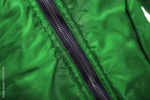 Close up of green jacket zipper , winter fashion outfit. Jacket isolated on white background.