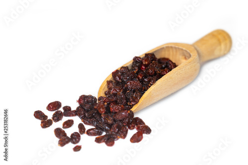 Closeup of dried red barberries, a good source of vitamin C, presented on a small wooden scoop
