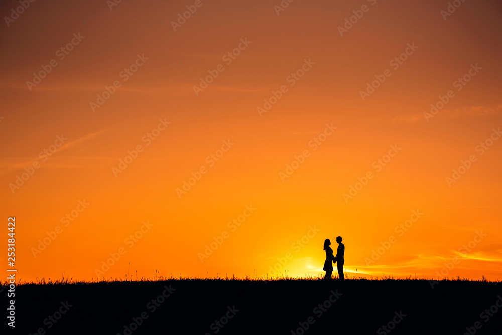 silhouette of a couple in love hugging together