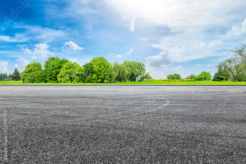 Empty asphalt square ground and green forest in summer