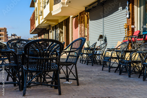 Empty tables and chairs in a street cafe