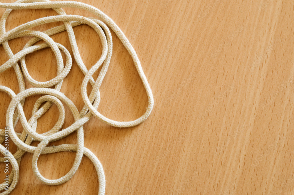 Tangled string on wooden table. Tangled string on wooden table.