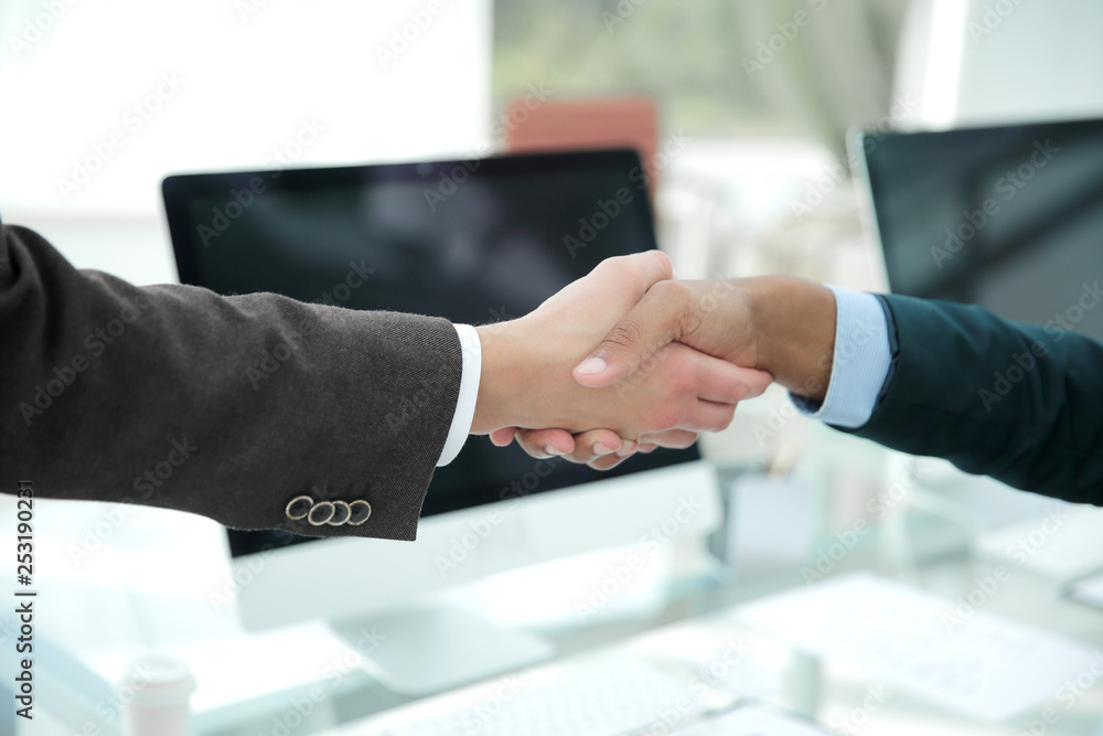 handshake financial partners over a Desk in the office