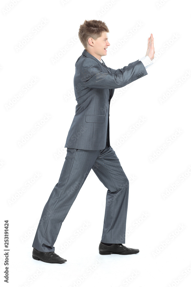 in full growth. modern businessman,moving the wall with his hands, in full growth. modern businessman,moving the wall with his hands,