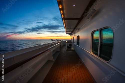 Open deck of a luxury cruise ship in the middle of the sunset