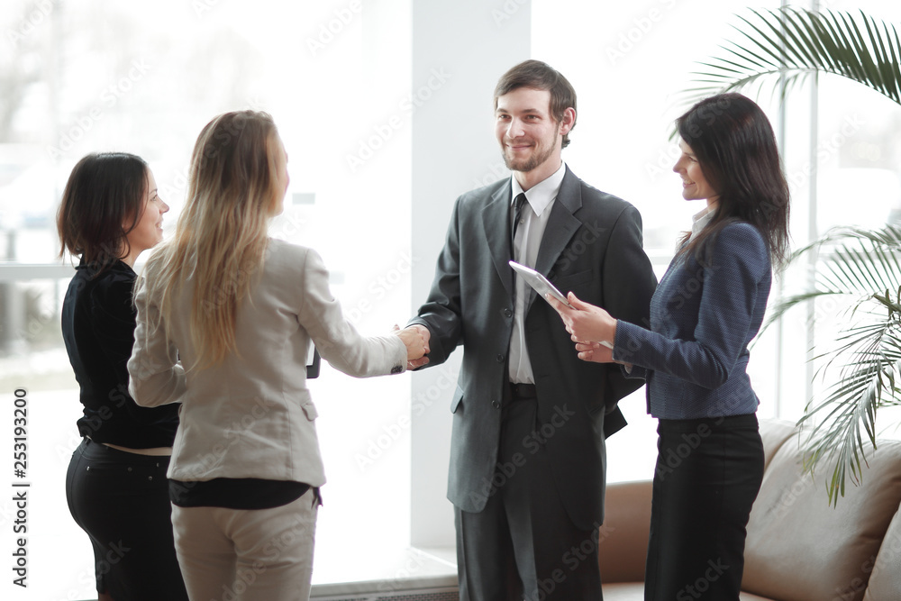 close up.handshake business partners and applauding business team. close up.handshake business partners and applauding business team.