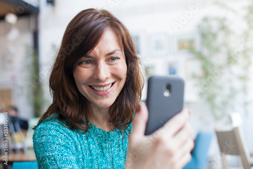 Wallpaper Mural portrait of beautiful woman taking selfie with smartphone Torontodigital.ca