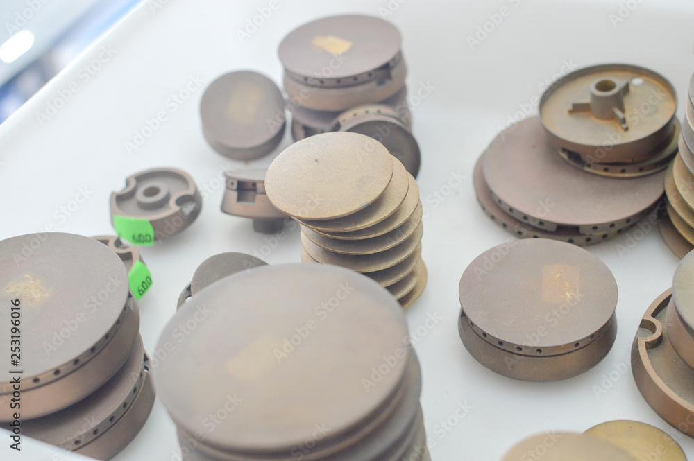 Gas plates spare parts for cooker, product shopping display background. Closeup on golden and gray shiny round shape elements of household appliance. Gas plates spare parts for cooker, product shopping display background. Closeup on golden and gray shiny round shape elements of household appliance.
