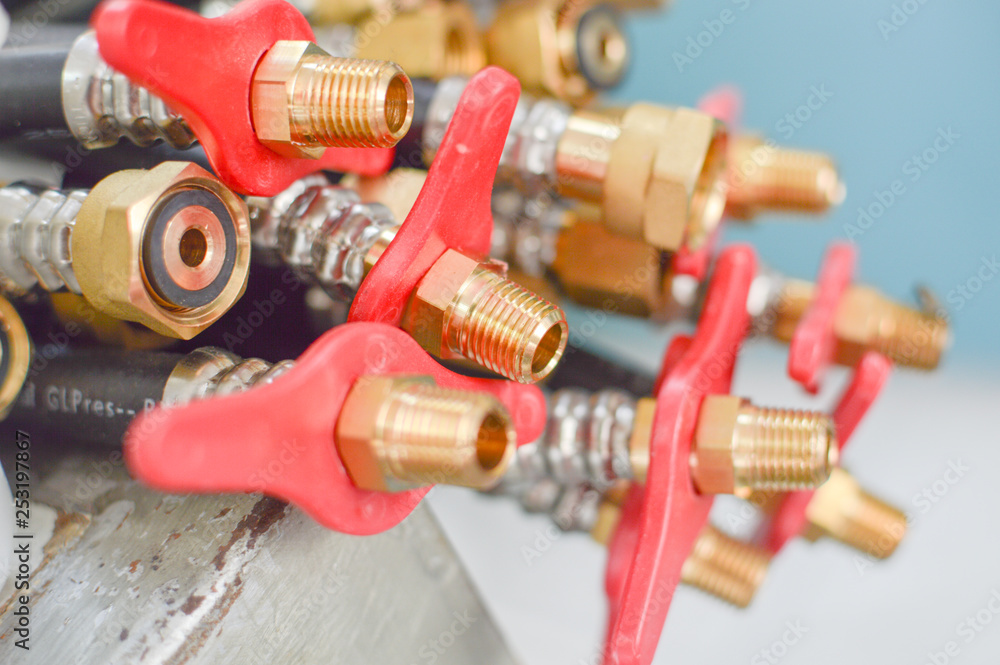 Close up on pile of shiny flexilble tubes equipment used for gas water or heating, macro structure shot of hose controller, display shelf abstract device texture pattern background. Close up on pile of shiny flexilble tubes equipment used for gas water or heating, macro structure shot of hose controller, display shelf abstract device texture pattern background.