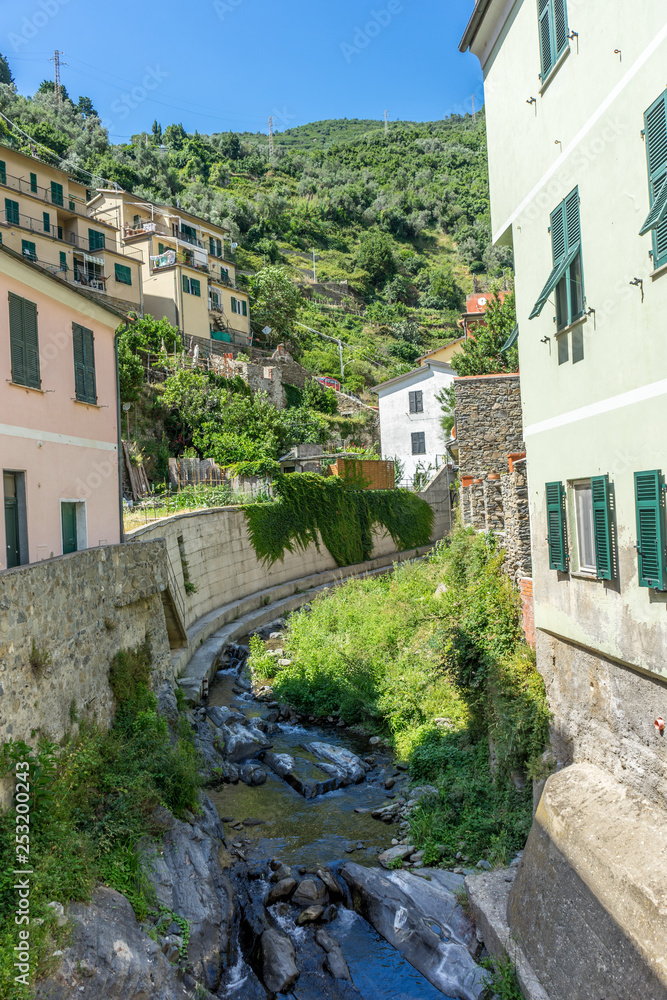 Italy, Cinque Terre, Vernazza, a stone building that has a rock wall Italy, Cinque Terre, Vernazza, a stone building that has a rock wall