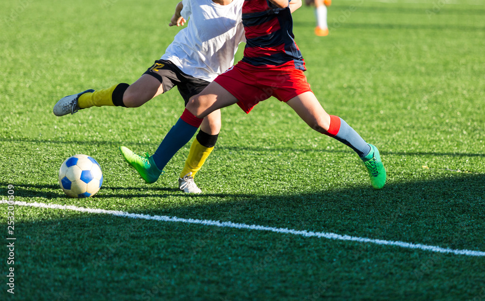 Football training soccer for kids. Boy runs kicks dribbles soccer balls. Young footballers dribble and kick football ball in game. Training, active lifestyle, sport, children activity concept 