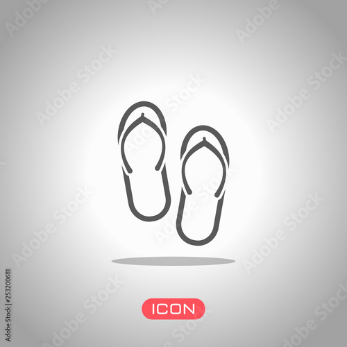 Beach slippers. Flip flops icon. Icon under spotlight. Gray background