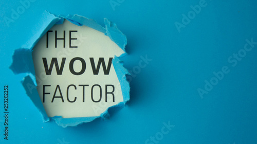 Torn paper with text The wow factor. Motivational concept