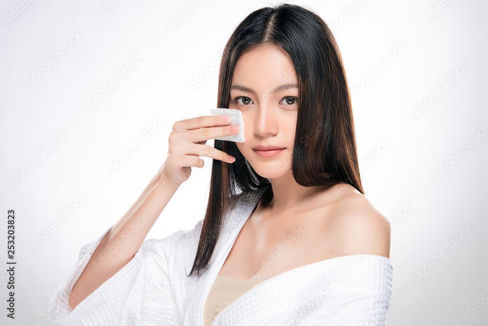 young beautiful woman cleaning face by cotton young beautiful woman cleaning face by cotton