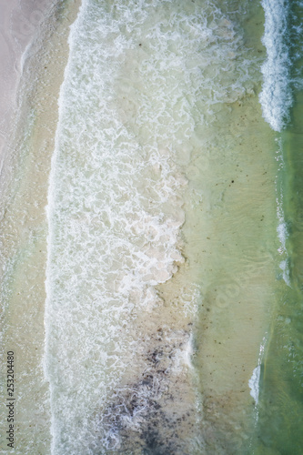 Waves crashing on beach aerial overhead