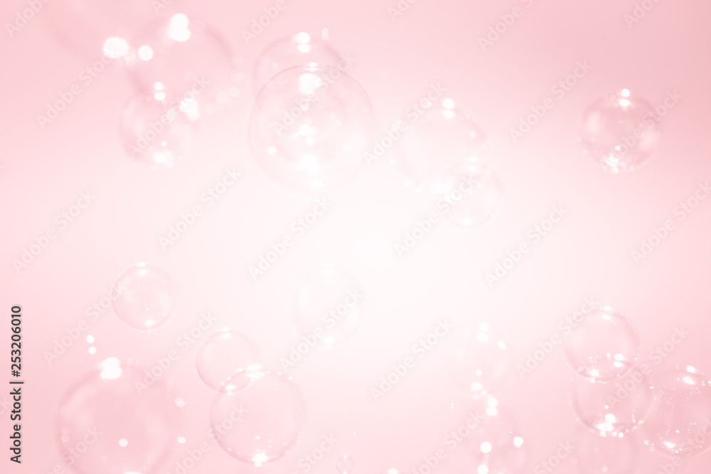 abstract background with soap bubbles floating on pink background.